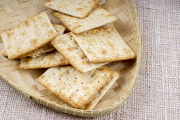 the cream cracker biscuit on the wooden background.