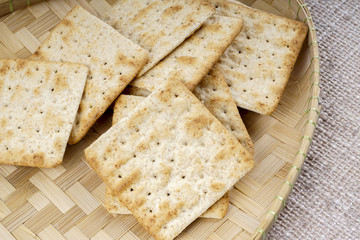 the cream cracker biscuit on the wooden background.