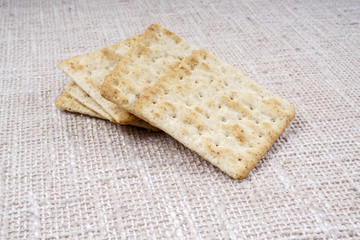 the cream cracker biscuit on the wooden background.