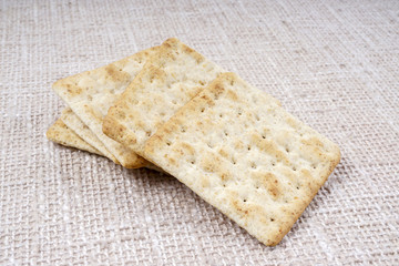 the cream cracker biscuit on the wooden background.