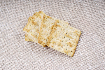 the cream cracker biscuit on the wooden background.