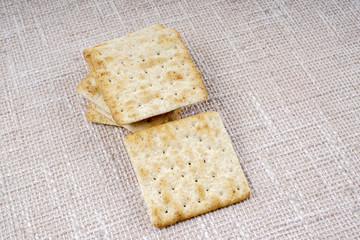 the cream cracker biscuit on the wooden background.