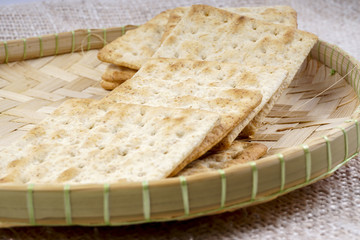the cream cracker biscuit on the wooden background.