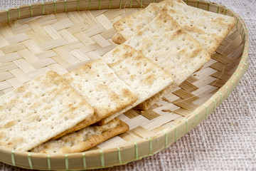 the cream cracker biscuit on the wooden background.