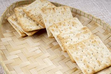 the cream cracker biscuit on the wooden background.