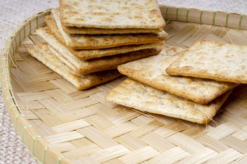the cream cracker biscuit on the wooden background.