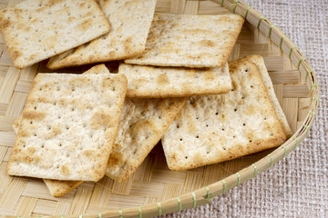 the cream cracker biscuit on the wooden background.