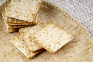 the cream cracker biscuit on the wooden background.