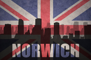 abstract silhouette of the city with text Norwich at the vintage british flag