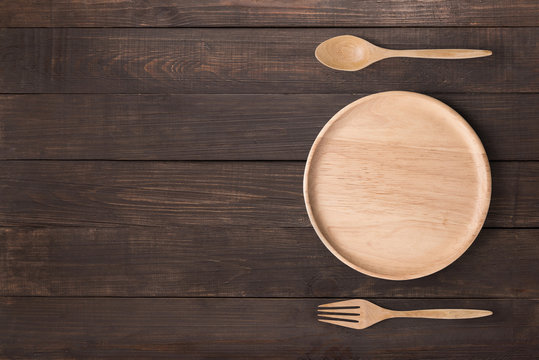 Eating concept. Wood dish, wood spoon and wood fork set 