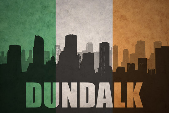 abstract silhouette of the city with text Dundalk at the vintage irish flag
