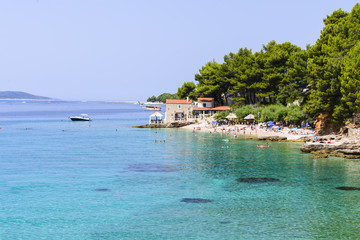 Tourists enjoing the beaches of Bol, Croatia