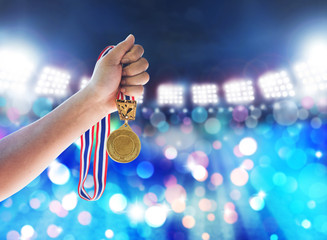 Plakat Man holding up a gold medal against,win concept.