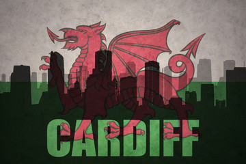 abstract silhouette of the city with text Cardiff at the vintage wales flag