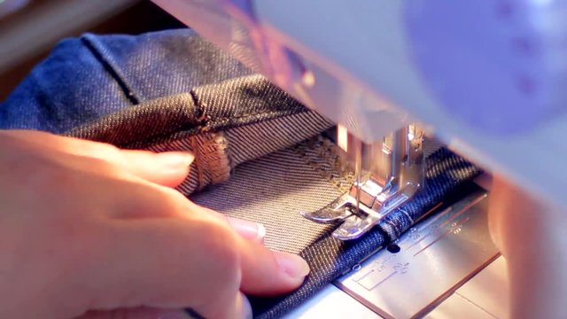 Sewing machine hemming pants blue
