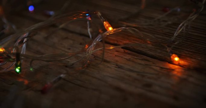 Close-up of christmas lights glowing on a plank