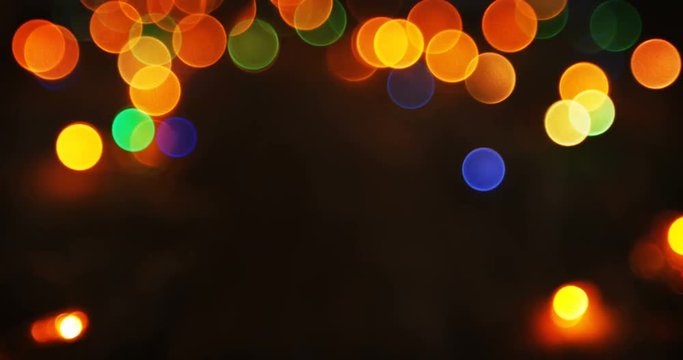 Bokeh of colorful christmas lights glowing on a plank