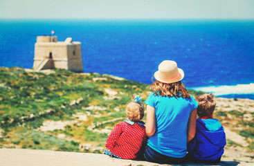 family travel -mother with two kids looking at scenic view