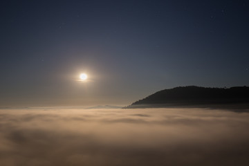 Fototapeta premium moon and fog in the morning with mountain at Khao Kho, Thailand