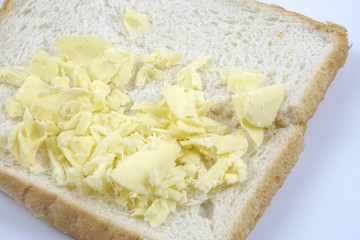 Fresh whole grain bread cut in half on white background