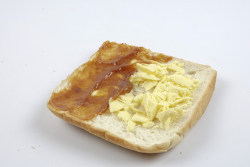 Fresh whole grain bread cut in half on white background