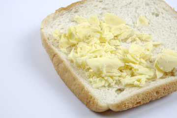 Fresh whole grain bread cut in half on white background