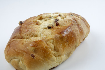 Fresh whole grain bread cut in half on white background