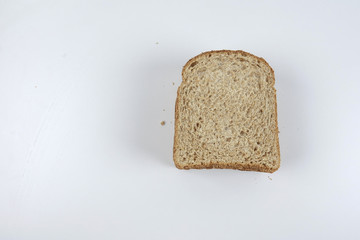 Fresh whole grain bread cut in half on white background