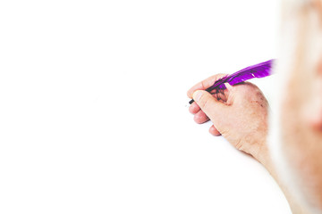 man with beard, writes purple pen on white background