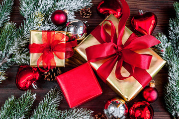 gifts boxes with fir branches on wooden background top view