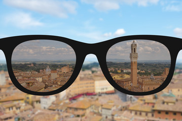 Clear image in sun glasses against blurry and sunny landscape