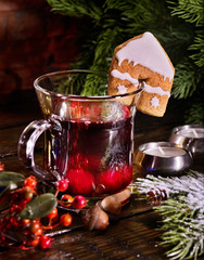 Winter hot drink. Warming mulled wine with cookie in form of house.