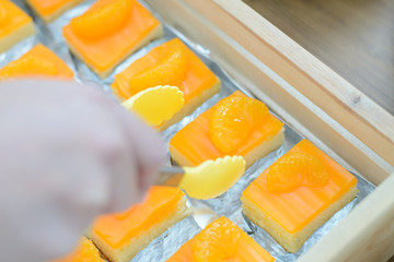 piece of orange cake in wooden box at the party