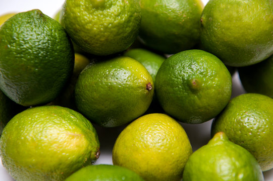 Group of ripe limes on white background