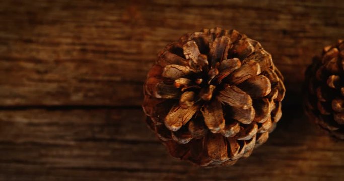 Pine cones on wooden plank