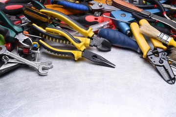 Set of tools on grey metal background, copy space