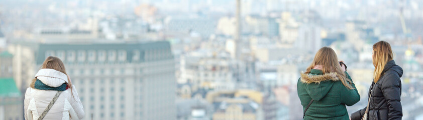 young people look at the city skyline from a height