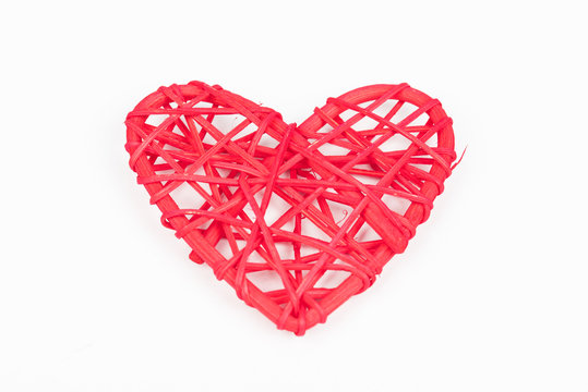 Red woven Valentines day/Christmas/ Mothers day/ anniversary decorations - heart isolated, on white background. Wicker heart. Closeup.
