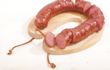 Traditional Dutch smoked sausage called Rookworst on wooden background