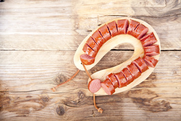 Traditional Dutch smoked sausage called Rookworst on wooden background