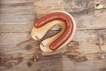 Traditional Dutch smoked sausage called Rookworst on wooden background
