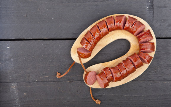 Traditional Dutch smoked sausage called Rookworst on wooden background