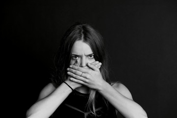 Speak no evil. The girl closes your mouth. Long hair