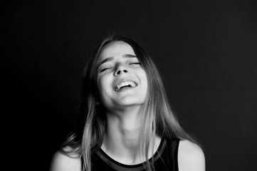 Emotional portrait of a beautiful girl with long hair. Broad good-natured happy smile