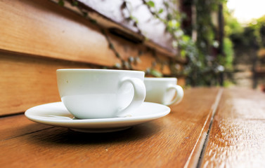 cup of hot coffee on table, over light and retro tone [blur and select focus background]