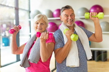 Senior couple exercising in gym
