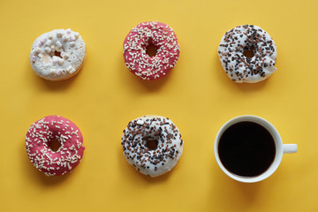 Five donuts with cup of coffee.