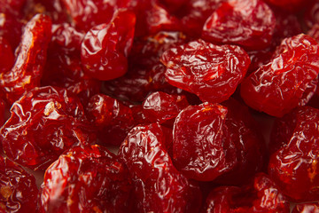 Dried cherries close up background. Heap of glossy red cherry. Top view.