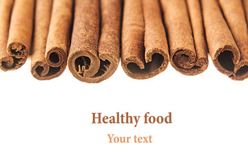 Cinnamon sticks closeup on white background. Isolated. Decorative border of cinnamon sticks spice.