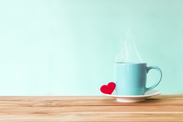 Coffee cup mug with red heart shape on wooden table , Romance